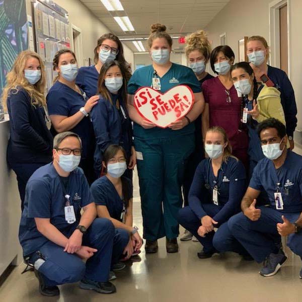 Medical staff with “Sí Se Puede SA” heart
