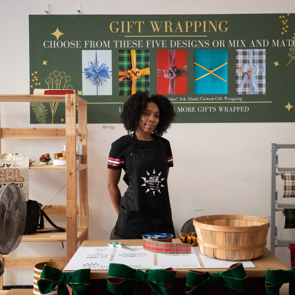 Women behind gift wrapping table